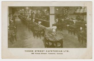 Black and white photograph of a restaurant interior.