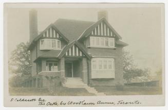 Black and white photograph of mock Tudor house.