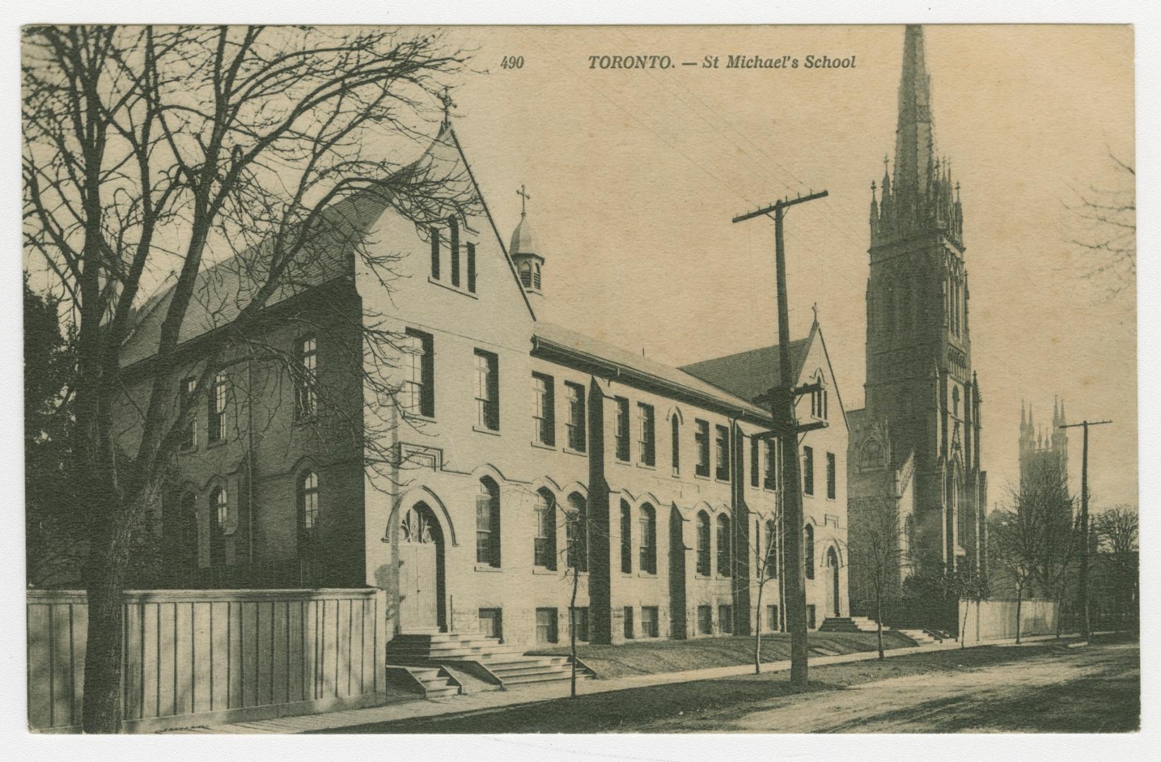 Picture of street scene with school building and two church towers. 