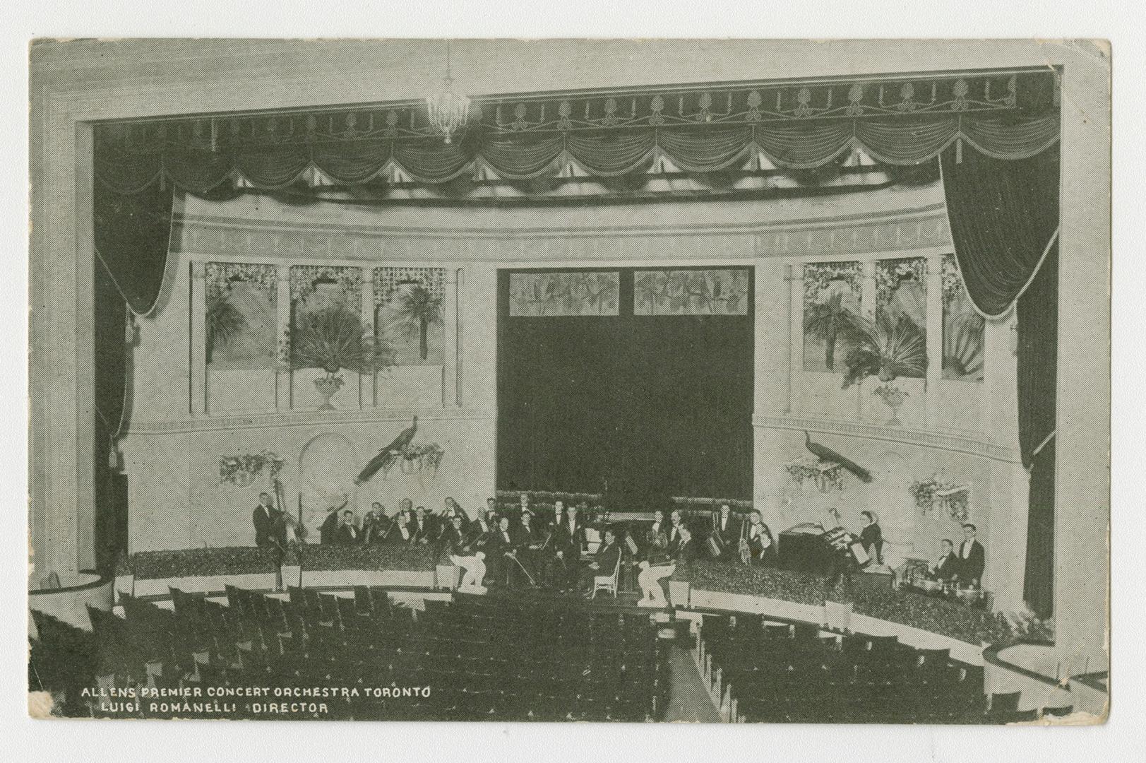 Picture of interior of a theatre with orchestra members. 