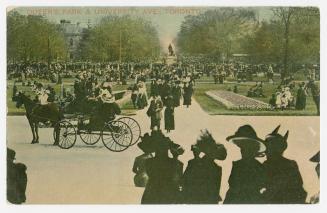 Colorized photograph of large crowd gathered in an urban park.
