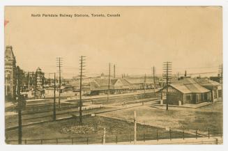 Sepia-toned postcard depicting a photo a railway yard with caption, "North Parkdale Railway Sta ...