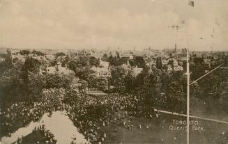 Black and white photograph (aerial view) of a huge crowd of people walking on pathways and lawn ...