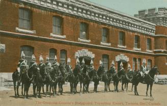 Colorized photograph of uniformed men on horseback in front of a large castle-like structure.