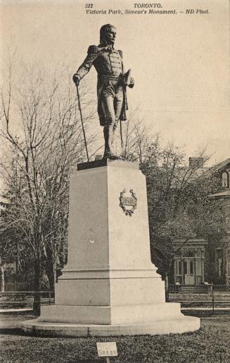 Picture of a large monument with man in military uniform on top. 