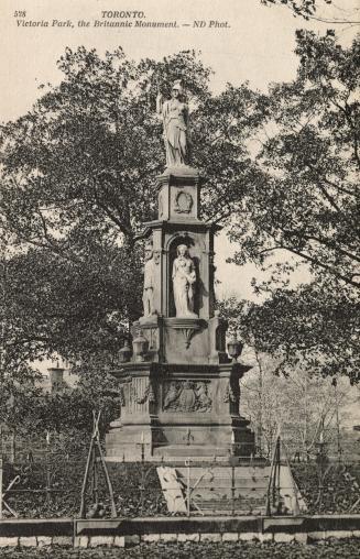 Picture of a large monument with several figures surrounded by trees. 