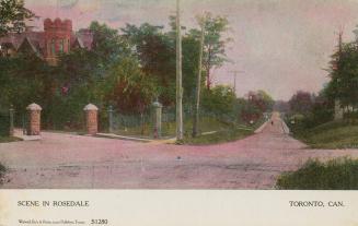 Colour postcard depicting a crossroads intersection with a large house in the distance, with ca ...