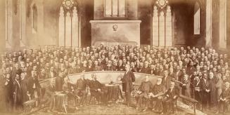 A composite photograph of a conference meeting taking place in a church, with several dozen men ...