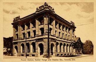 Sepia toned photograph of a three story, Edwardian commercial building.