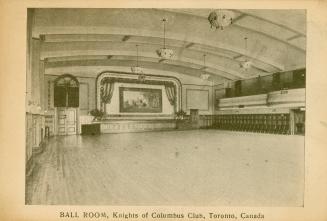 Black and white photograph of a large, empty ball room.