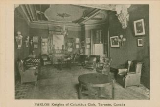 Black and white photograph of a large, ornate living room.