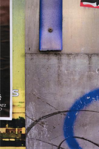 A close-up photograph of a surface covered in posters and graffiti. Portions of posters, some o ...