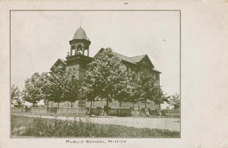 Black and white photograph of a three story school with cupola bell tower.