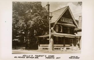 Sepia-toned postcard depicting an image of a home being used for tourist lodging. The caption a ...