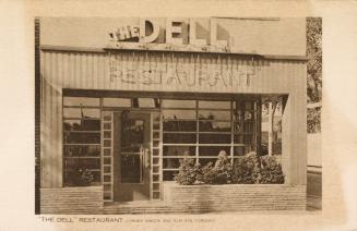 Sepia-toned photo postcard depicting the front of a restaurant with caption at the bottom of th ...