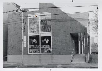 Photo of library building and new addition with large window. 