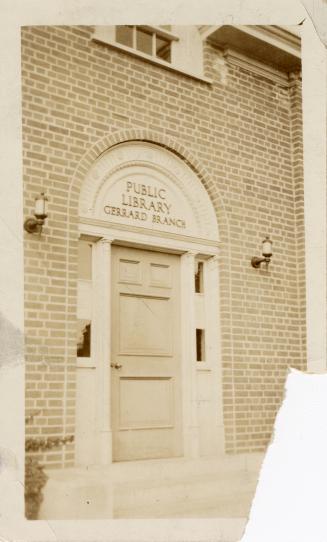 Photo of arched doorway of library branch. 