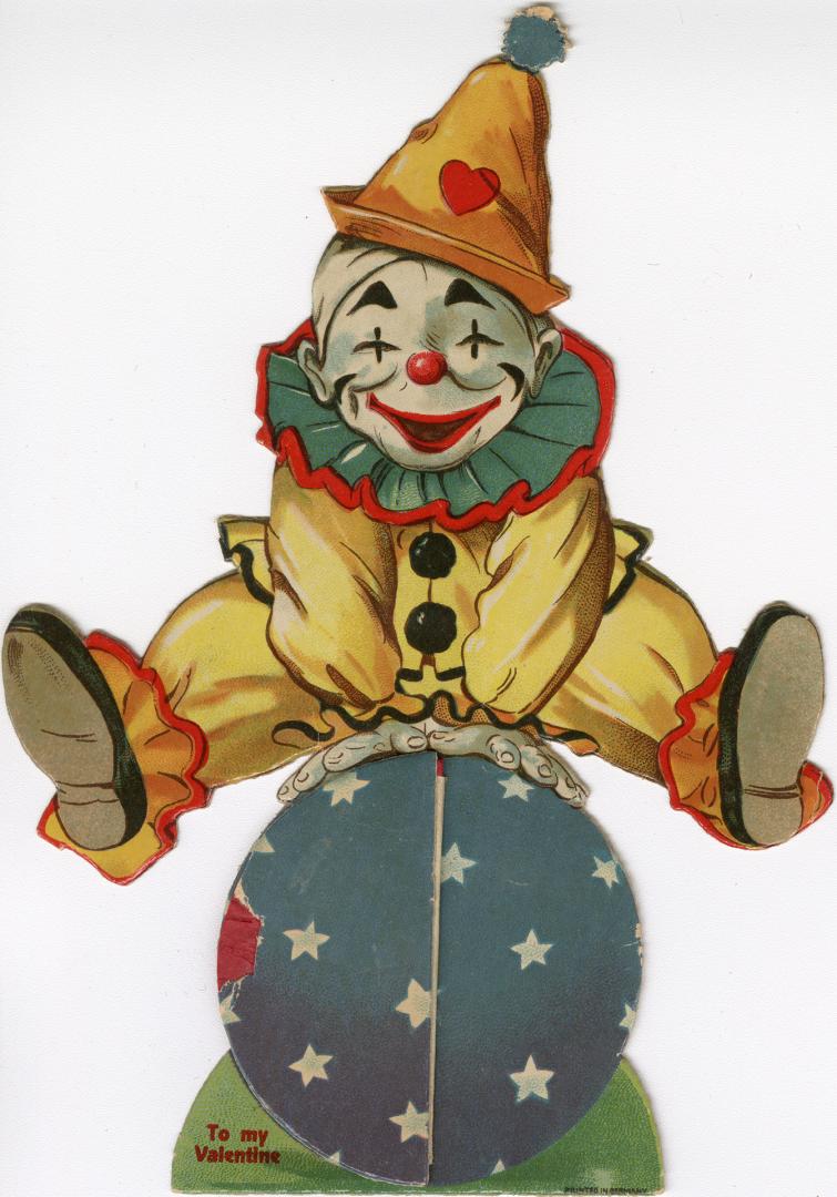 An accordion style pop-up card. A clown balances on top of a ball. Lifting up one side of the b ...