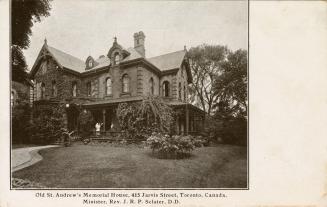 Black and white photograph of large Victorian house.