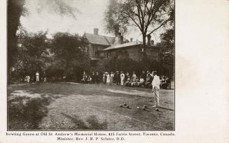 Black and white photograph of people lawn bowling.