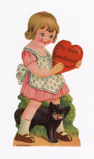 A girl stands in front of a bush. She is holding a large red heart. A black cat is at her feet. ...
