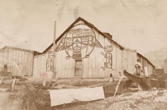 A photograph of two barn-like houses, one of which has an illustration of an Indigenous Thunder ...