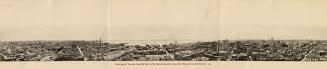 Black and white photograph of a large city taken from a position many stories up from street le ...