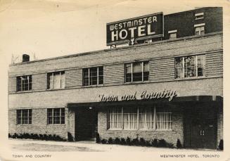 Black and white photograph of a mid-century , two story hotel.