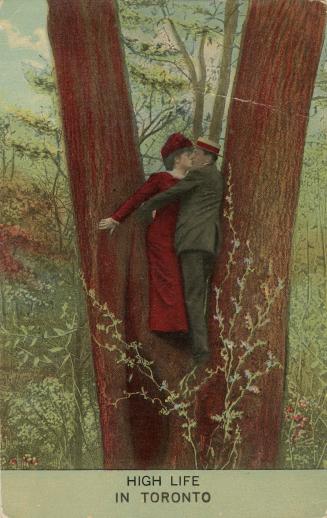 A man and a woman standing in V of a tree crotch exchanging a kiss.