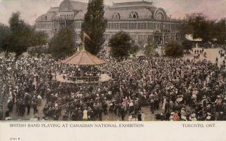 Colorized photograph of a massive crowd standing around an outdoor, circular bandstand with a l ...