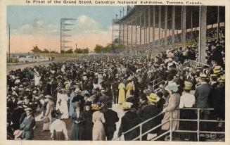 Colorized photograph of a large crowd in the stands of a race track.
