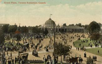 Colorized photograph of a domed building in the background with crowds of people and cars on ro ...
