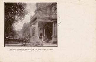 Black and white photograph of a covered front entrance way to a large house.
