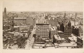 Black and white photograph of an aerial view of a large city downtown area with skyscrapers.