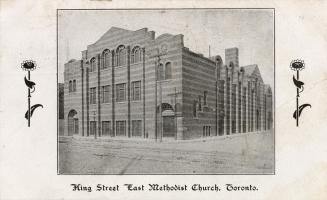 Black and white photograph of a very large church building spanning an entire city block.