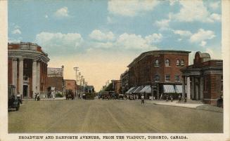 Colorized photograph a city street with two story buildings on either side.