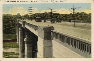Colorized photograph of cars and a streetcar crossing a concrete and steel bridge.