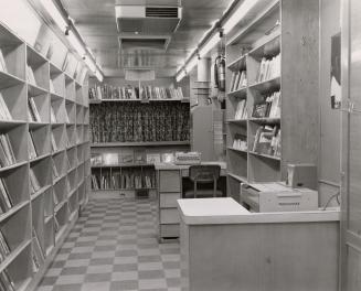 Interior of bookmobile showing fully stocked shelves.
