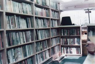 Interior of bookmobile showing shelves of books. 