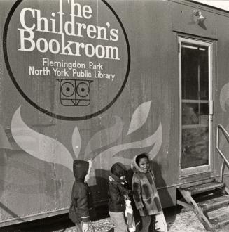 Picture of children outside a bookmobile in winter.