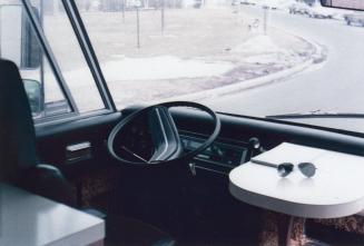 Interior of bookmobile showing driver's seat. 