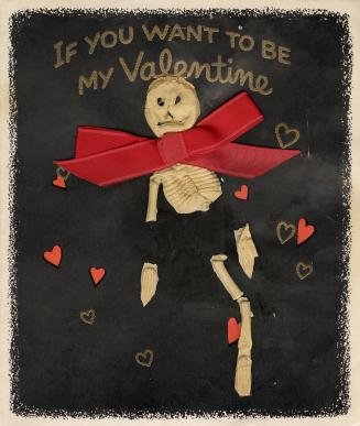 A skeleton made of ceramic or plaster has been affixed to the front of this card. Behind it is  ...