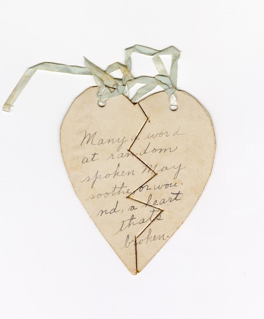 Two separate halves of a broken heart are tied together with a ribbon. Includes an inscription. ...