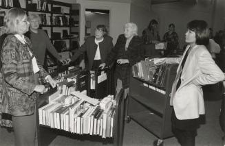Picture of group of people shelving library books.