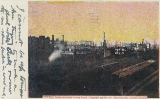 Colour postcard depicting a distant view of the damage from the 1904 fire of Toronto amid a red ...