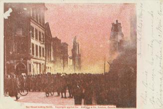 Colour postcard depicting a large crowd on Bay St. looking south towards the 1904 fire of Toron ...