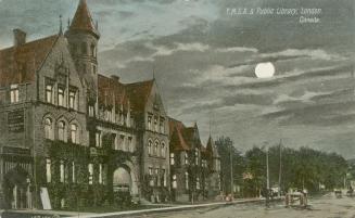 Picture of street at night with full moon and large buildings on one side of the street. 