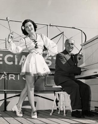 Black and white photograph of Ivor "Jack" Ayre and showgirl on stage.
