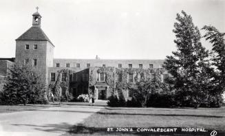Black and white photograph of several two story, public buildings.