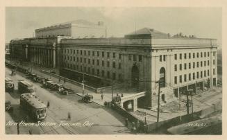 Black and white photo postcard depicting an exterior view of Union station, with the caption st ...